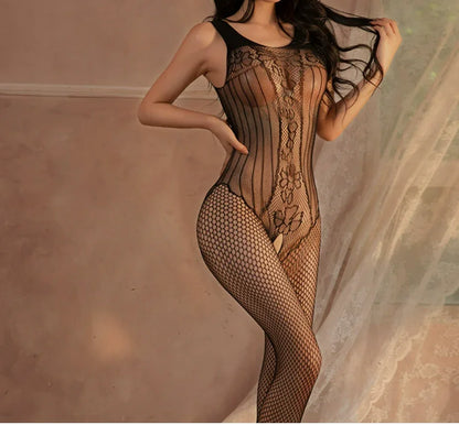 Woman wearing black fishnet lace bodysuit lingerie, romantic bedroom setting