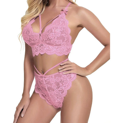 Woman wearing pink lace lingerie set with strappy details, floral pattern, and scalloped edges