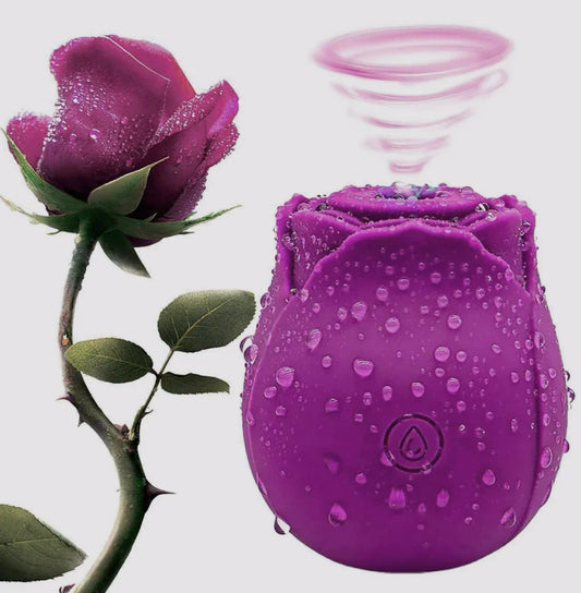 Purple rose-shaped couples game kit product with water droplets, next to real rose