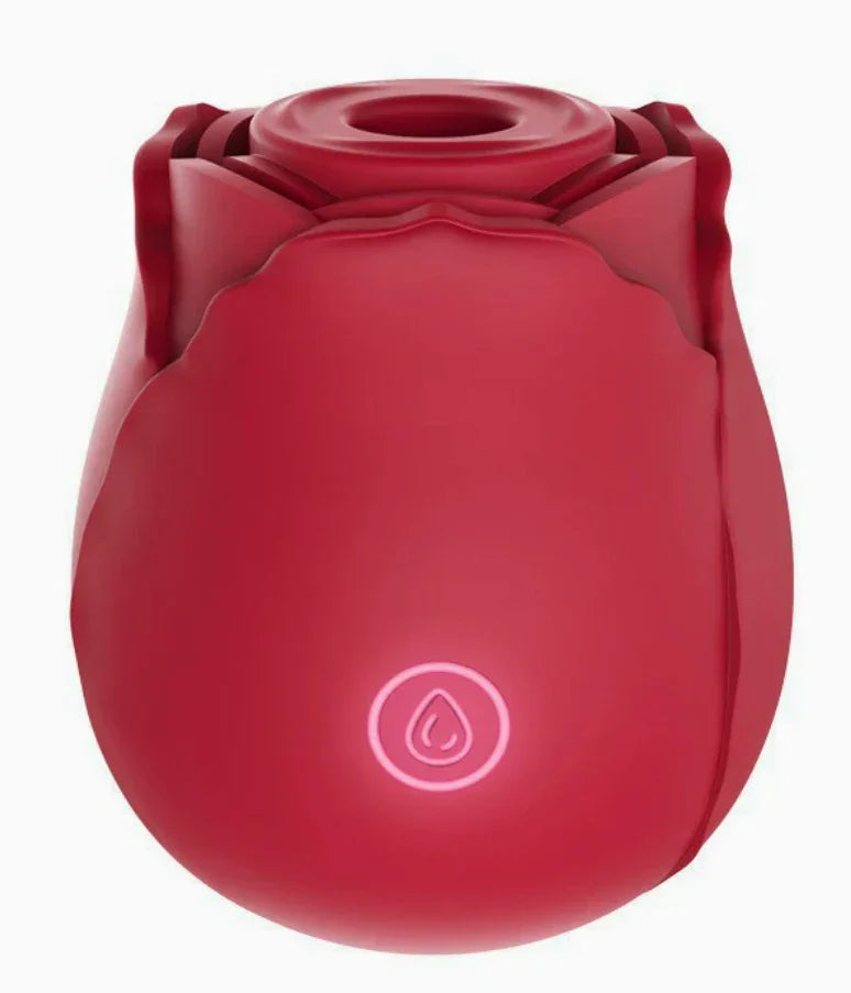 Red rose-shaped silicone couples game accessory with glowing button, white background